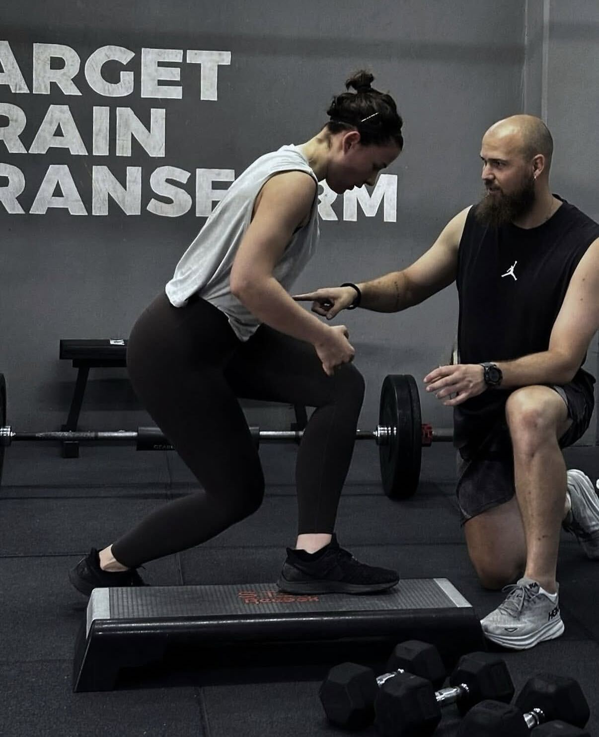 A FIIT coach guiding a member through a step-up at the training room in Paphos